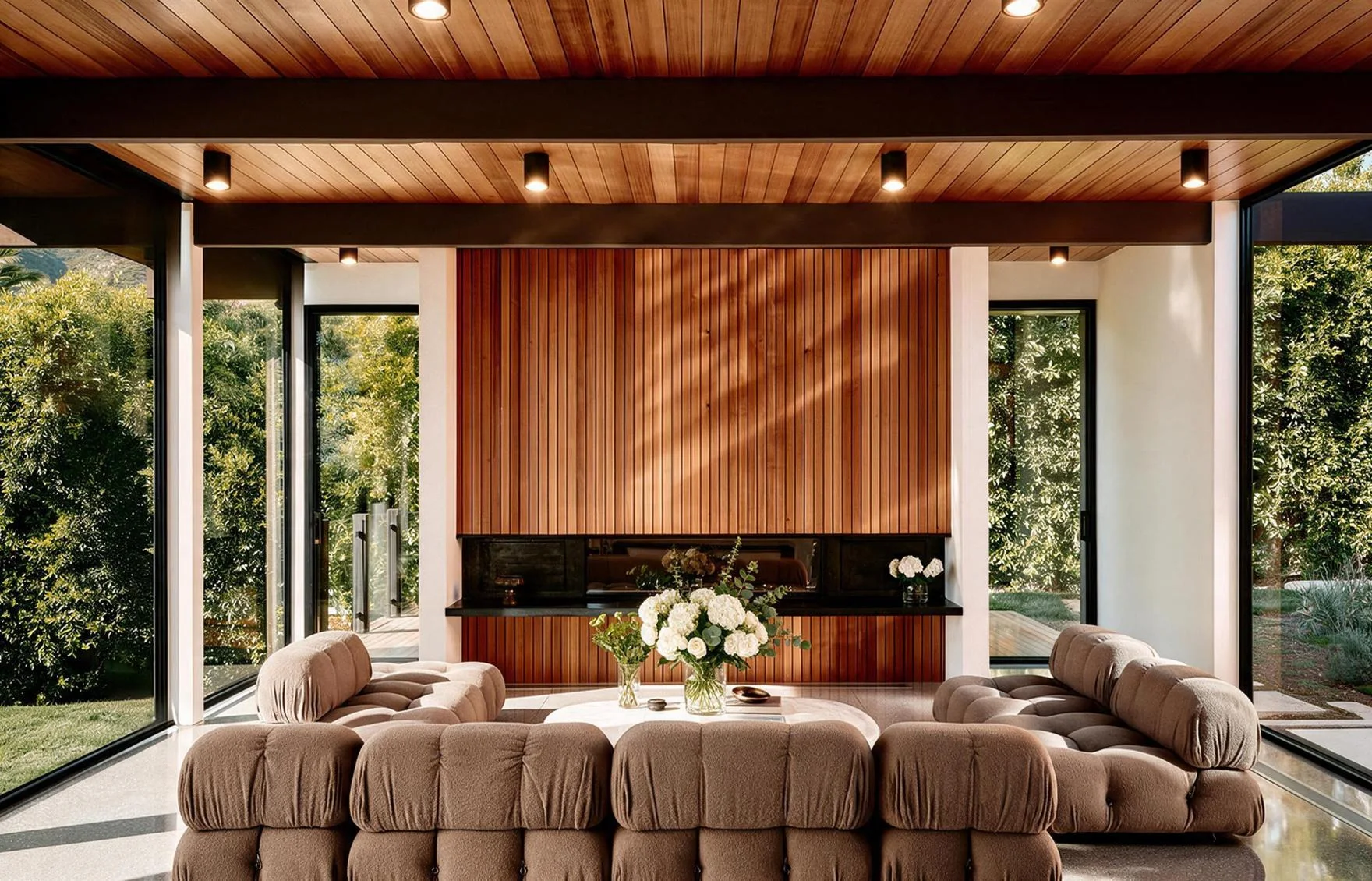 The living room: the sectional sofa before the timber fireplace wall.