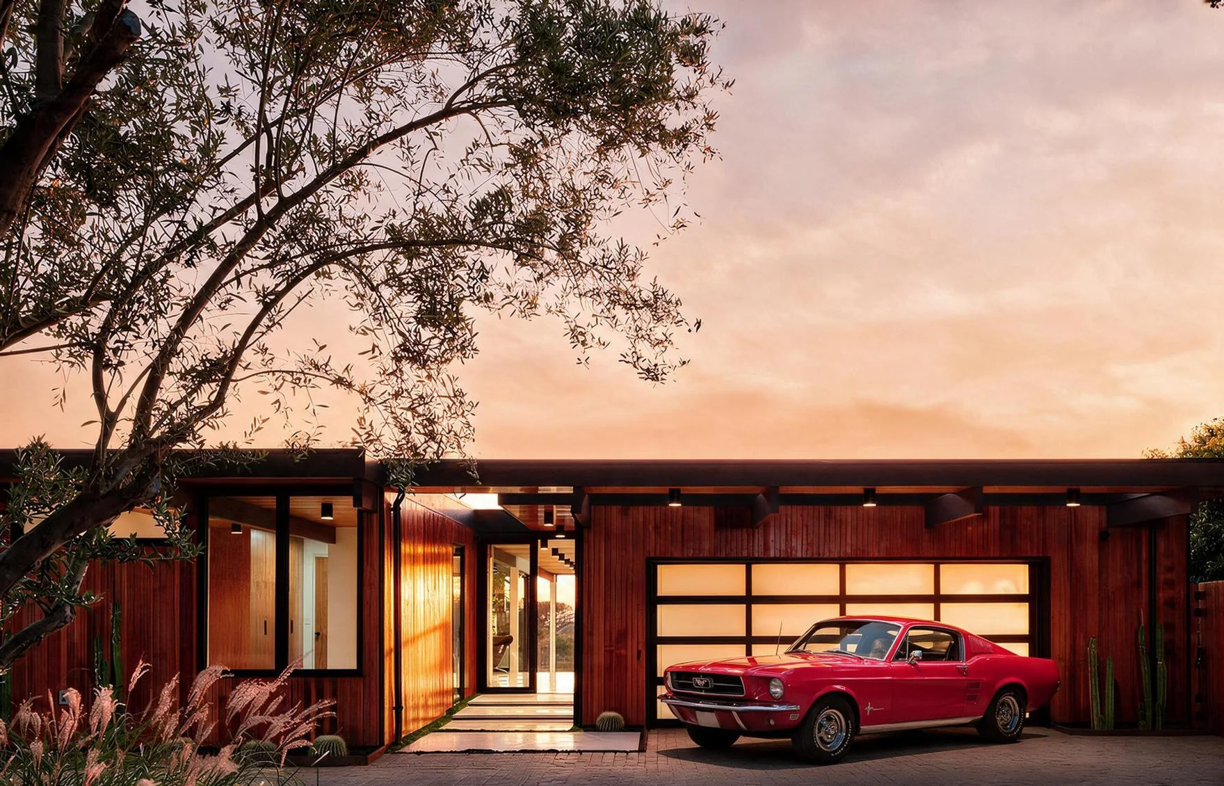 The courtyard at sunset, the garage and a red vintage car.