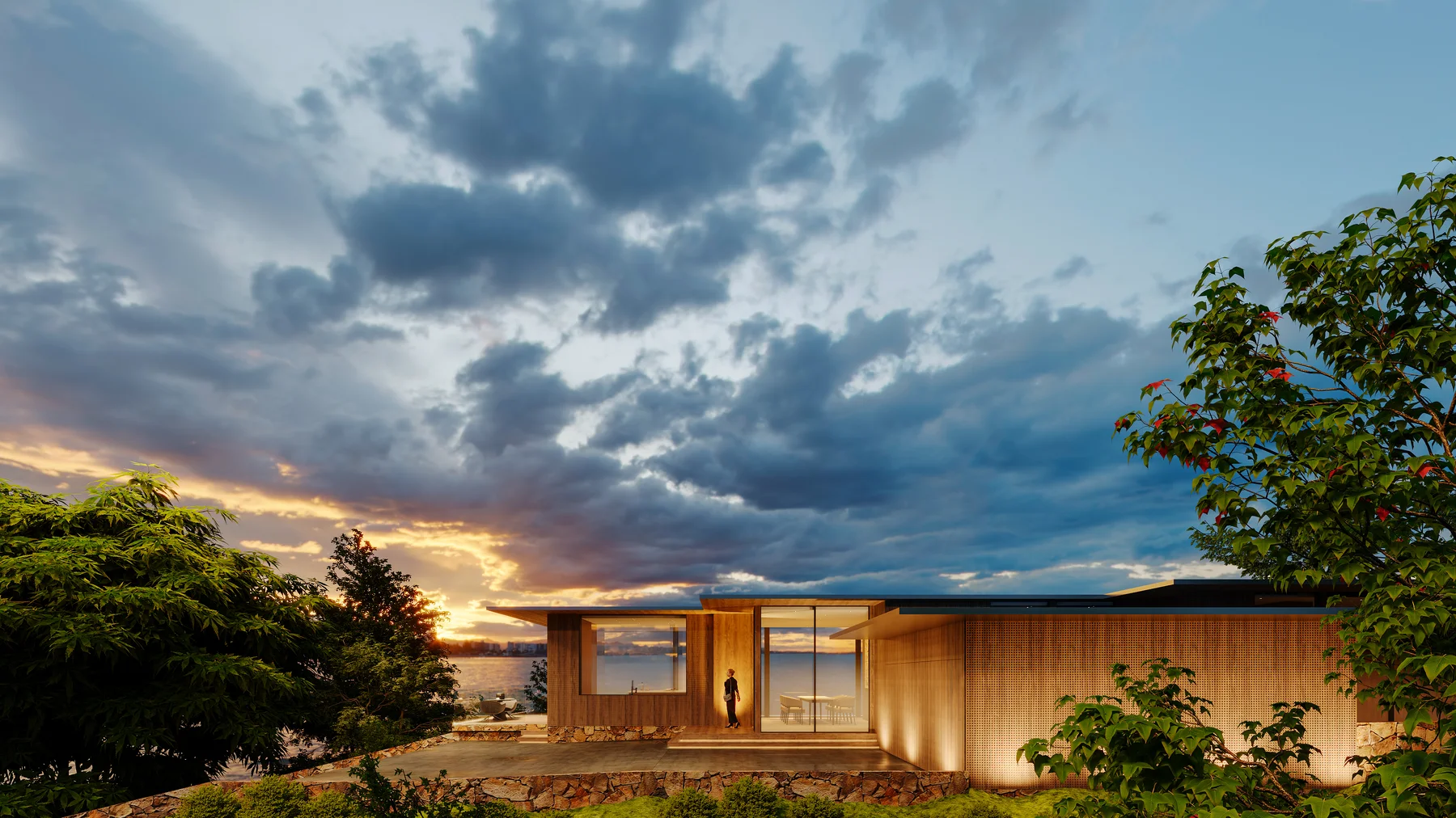 The house at dusk, a figure on the terrace, cloud-lit sky beyond.