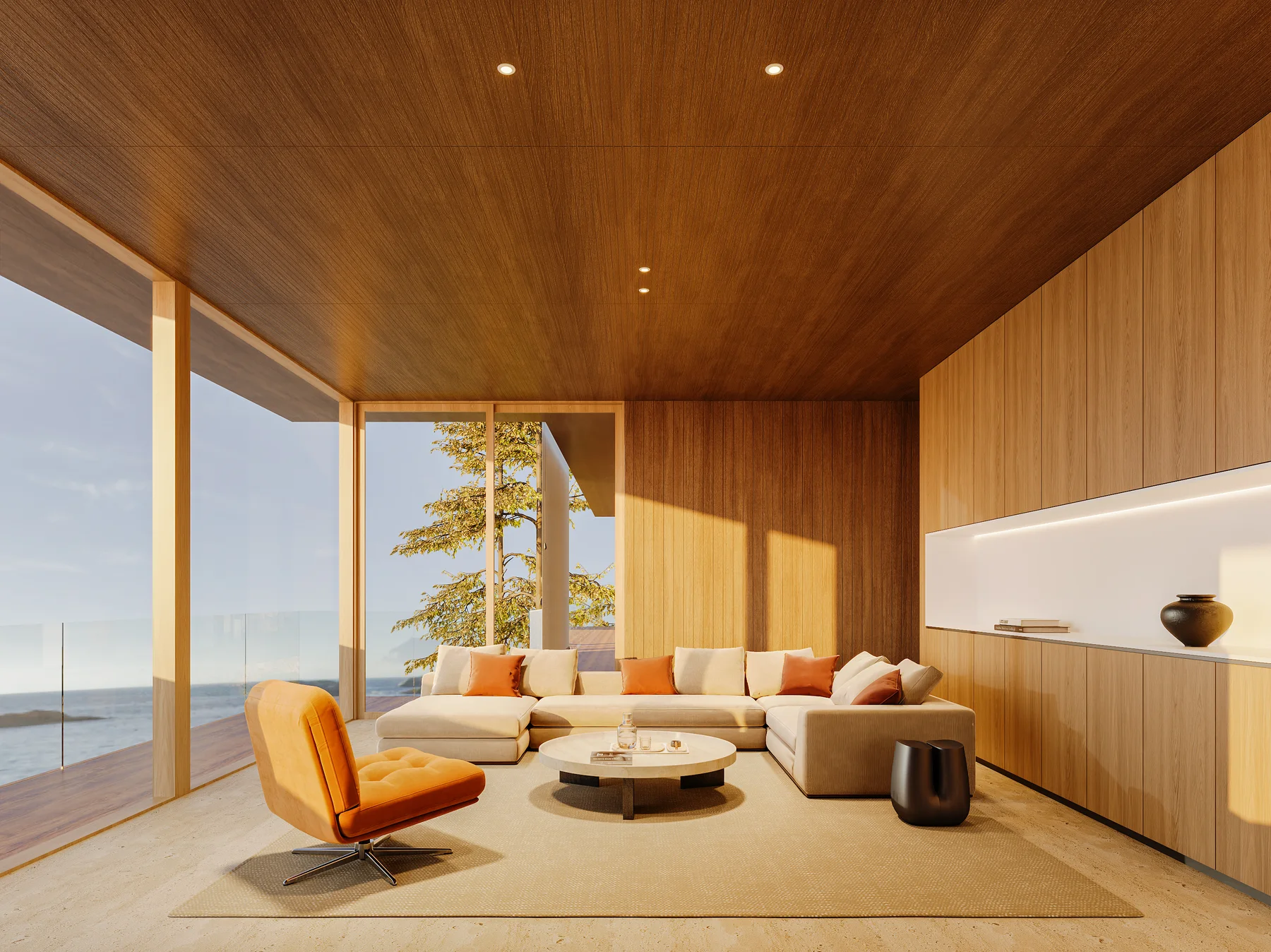 The living room at dusk: a wood ceiling, a sectional and orange lounge chairs, the water beyond the glass.