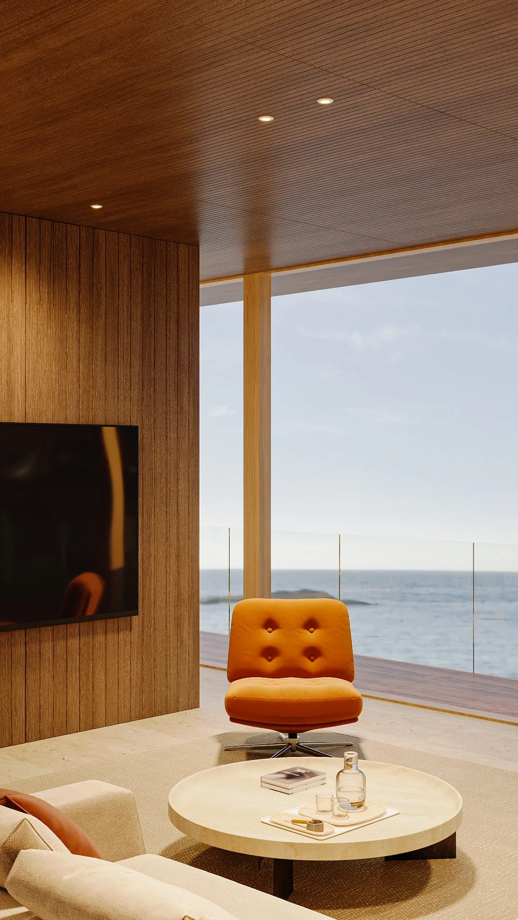 A second lounge view by day, the television wall and orange chair.